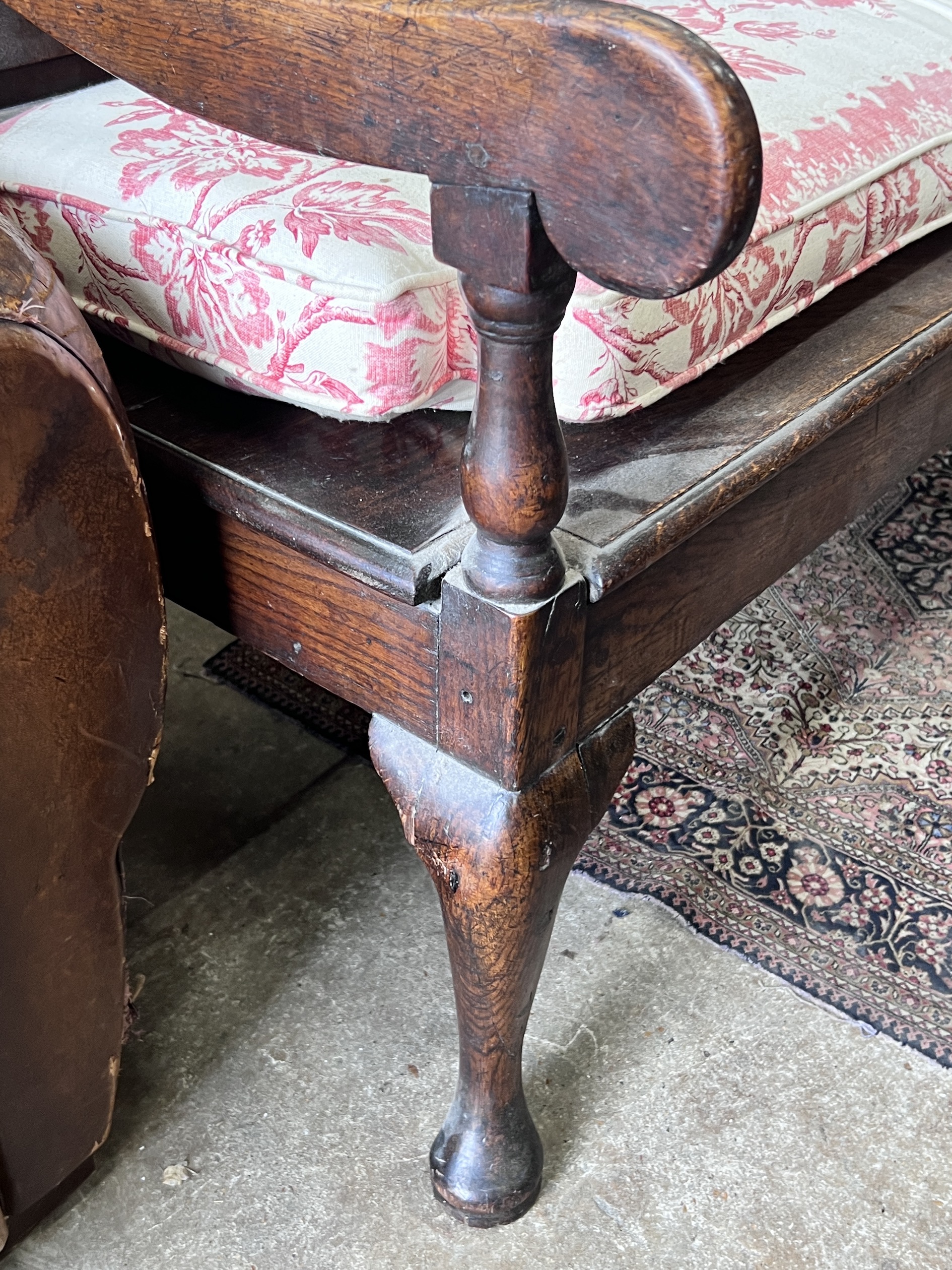 An 18th century panelled oak settle with squab seat, length 184cm, depth 63cm, height 105cm